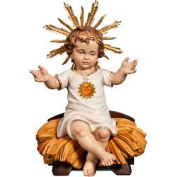 Menino Jesus vestido com Coração sentado na cama