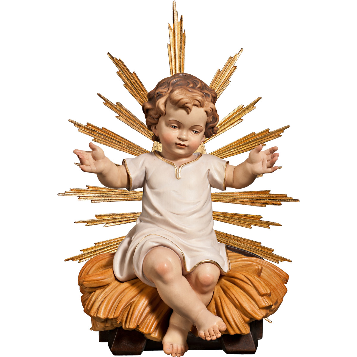 Niño Jesús vestido sentado en cuna con aureola
