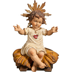 Gesù Bambino vestito con Cuore seduto su culla