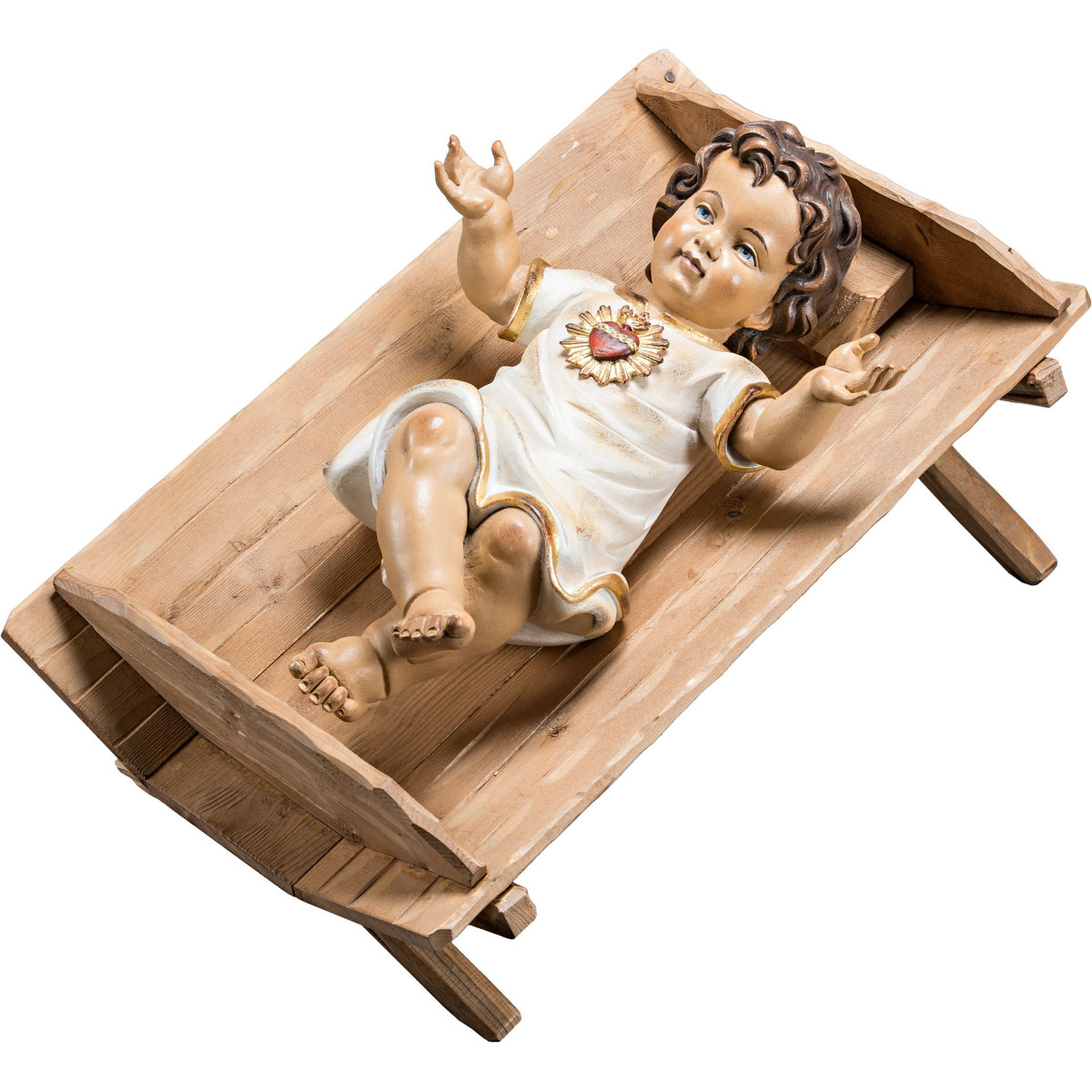 Jesuskind bekleidet mit Herz in einfacher Wiege