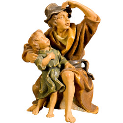 Herdsman sitting with kid