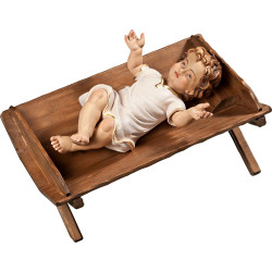 Menino Jesus vestido em cama simples