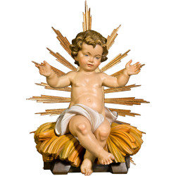 Niño Jesús sentado en cuna con aureola