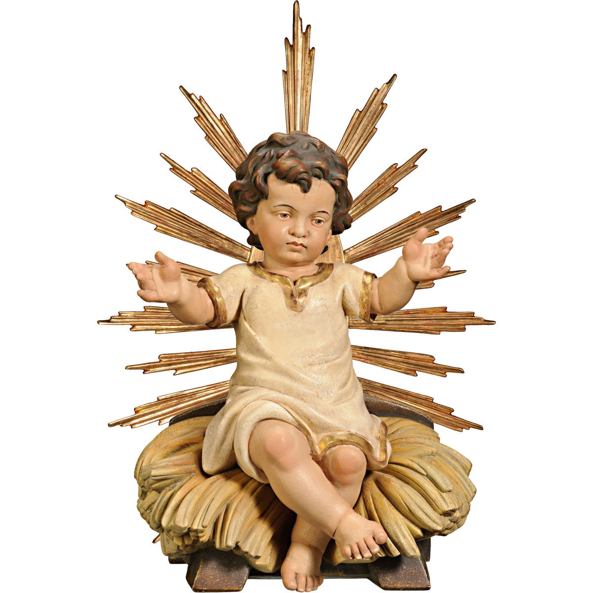 Niño Jesús vestido sentado en cuna con aureola