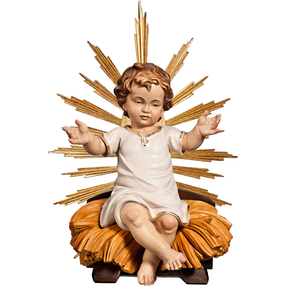 Niño Jesús vestido sentado en cuna con aureola